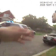 Still image from footage taken by Chicago police body camera shows the officer firing his weapon at a Jaguar convertible driven by Paul O'Neal, 18, on July 28. (Credit: Chicago Tribune)